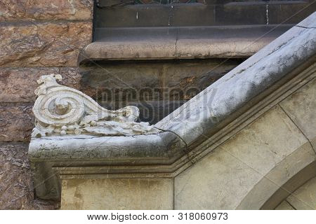 Photo Of A Building Facade Detail With Stone Texture, Cold Colours And Sunlght.
