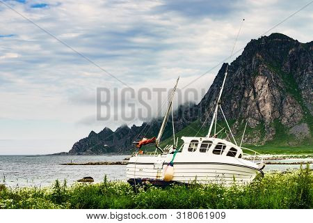 Seascape With Old Fishing Boat On Seashore And Mountains In The Background. Bleik Village, Andoya Is
