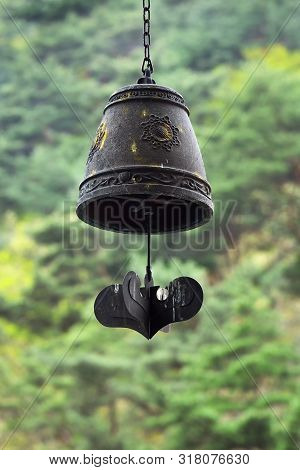 North Korea Mountains Of Myohan. Brass Buddhist Bell Hanging On Green Forest And Mountains Backgroun