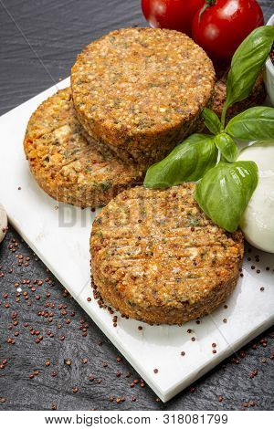 Tasty Vegetarian Burgers Made From Healthy Quinoa, Basil, Tomatoes And Mozzarella Cheese