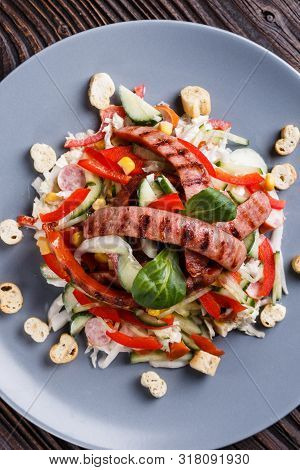 Salad With Grilled Sausage Paprica Cucumber And Croutons