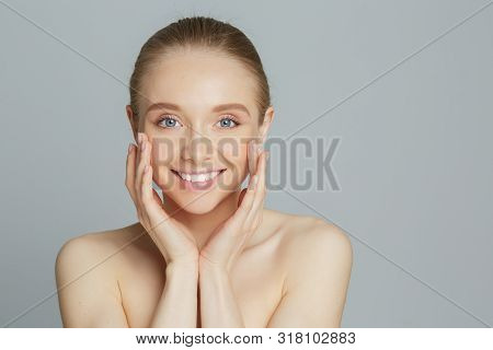 Portrait Of Beautiful Woman With Natural Make Up Touching Her Face.