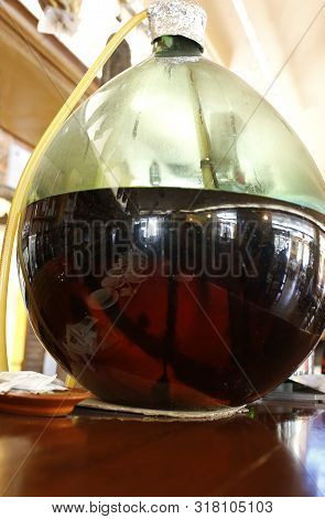 Traditional Competa Wine Served From Big Glass Globe. Delicious Wine Made Locally In Axarquia Provin