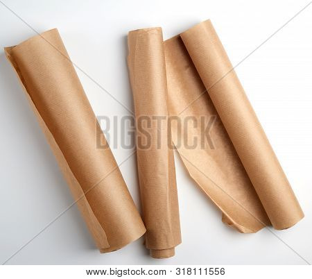 Three Rolled Rolls Of Parchment Baking Paper On A White Background, Top Viewthree Rolled Rolls Of Pa