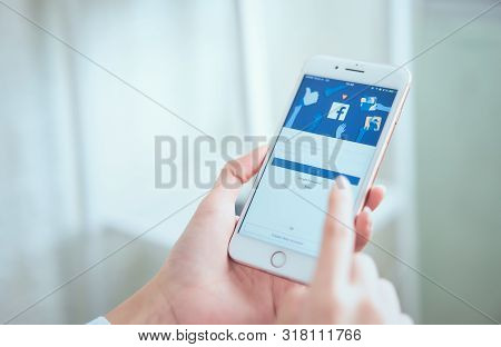 Bangkok, Thailand - August 21, 2019 : Woman Hand Holding And Is Pressing The Facebook Screen On Appl