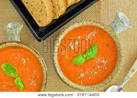 Homemade Zesty Tomato Basil Soup In Rustic Bowls With Whole Grain Bread In Horizontal Format Shot Fr