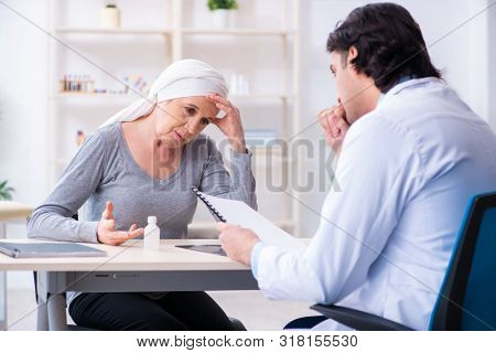 Young male doctor and female oncology patient 