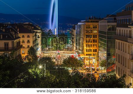 Geneva, Switzerland - August 10 2019: Dusk View Of Night City Streets And Illuminated Landmark Genev