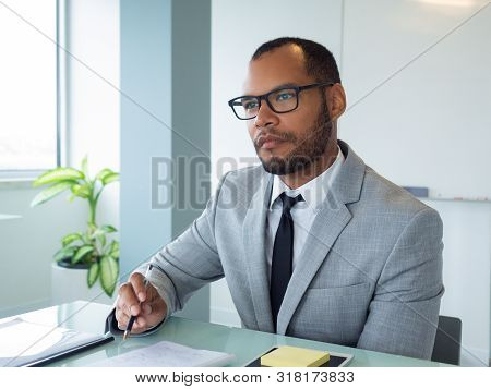 Focused Business Professional Listening To Speaker During Meeting Or Conference. Businessman Sitting