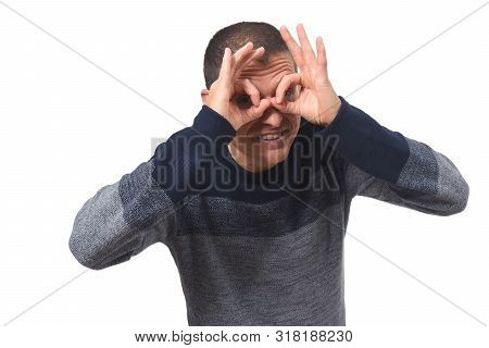 Man Looking Through Fingers As If Wearing Glasses On White Background