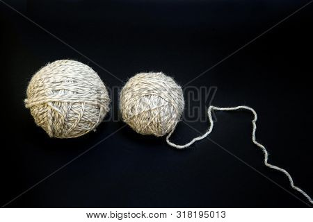White Balls Of Yarn For Knitting On A Black Background, Close Up