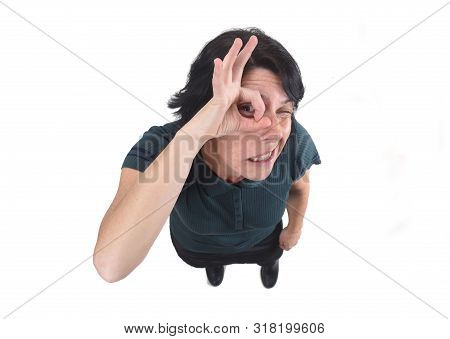 Woman Looking Through Fingers As If Wearing Glasses On White Background