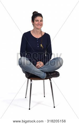 Woman Sitting In A Vintage Chair With The Lotus Pose