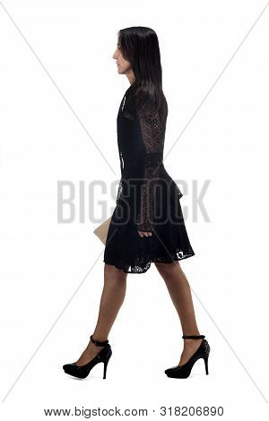 Full Portrait Of A Middle Age Woman Waliking And With Dress And Heeled Shoes Isolated On White