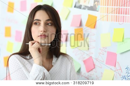 Portrait Of Businesswoman Standing In Modern Office And Looking Away With Gladness And Joy. Pensive 