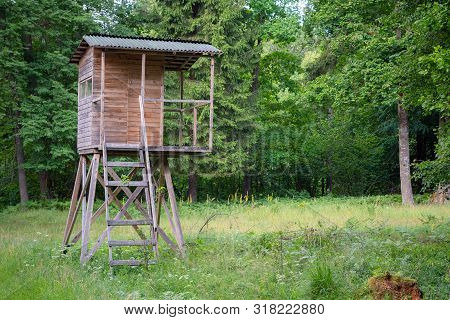Hunters Hut In The Forest By The Road. Hunter Tower Or Watch Post In The Wilderness. Hunter Post Is