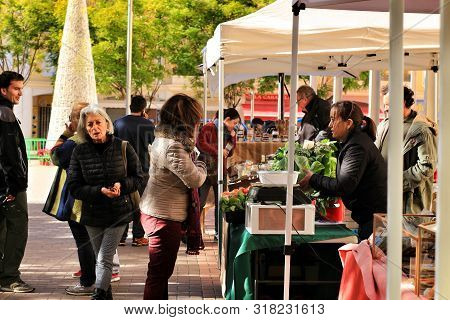 Elche, Alicante, Spain- December 1, 2018: People Buying In The Local Ecological Market In The Main S