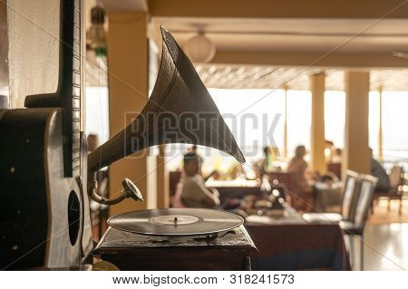 Old Gramophone, Guitar And People In Restaurant, Focus On Gramophone, Closeup