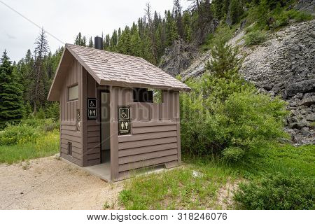 Rustic Pit Toilet Bathrooms Outdoors With One Stall And Handicap Access