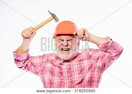 Home Improvement Repair. Man Bearded Laborer Wear Helmet Hold Hammer. Repair Workshop. Repair Concep