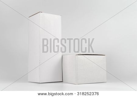 White Two Paper Boxes - Tall And Fat Lay On The White Background In Studio Shot With Clipping Paht.