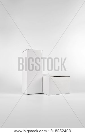 White Two Paper Boxes - Tall And Fat Lay On The White Background In Studio Shot With Clipping Paht.