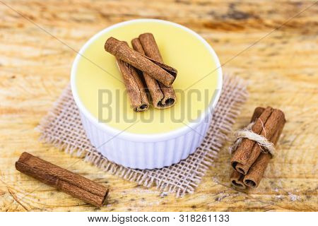 Dessert Of Curau. Brazilian Sweet Corn, Corn Mousse With Cinnamon On A Wooden Background. Typical Br