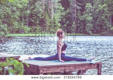 Young Yogi  Girl  Practicing Yoga, Stretching In Monkey God Exercise, Splits, Hanumanasana Pose On T