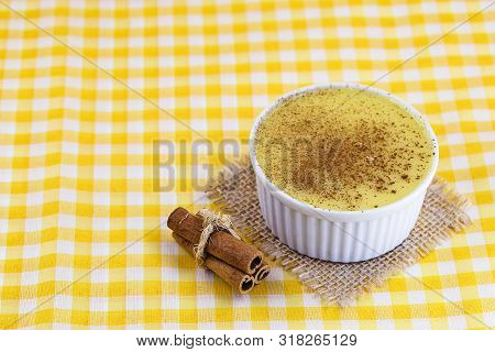 Dessert Of Curau. Brazilian Sweet Corn, Corn Mousse With Cinnamon On A Wooden Background. Typical Br