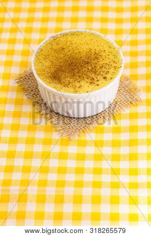 Dessert Of Curau. Brazilian Sweet Corn, Corn Mousse With Cinnamon On A Wooden Background. Typical Br