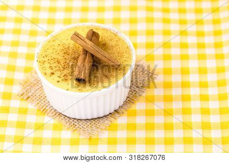 Dessert Of Curau. Brazilian Sweet Corn, Corn Mousse With Cinnamon On A Wooden Background. Typical Br