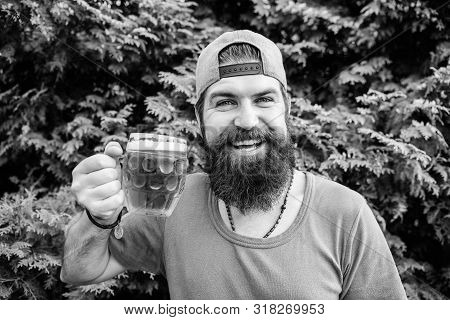 Relaxing With A Refreshing Drink In Summer. Hipster Enjoying Beer Drink On Nature. Bearded Man Drink