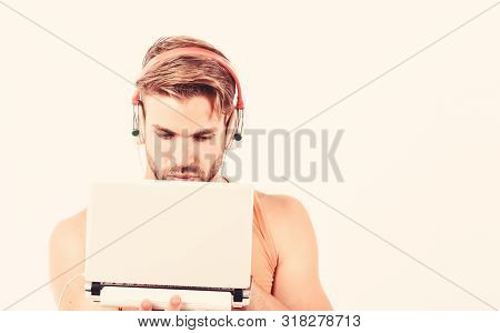 Searching For Favorite Music. Sexy Muscular Man Listen Audio. Man In Earphones Isolated On White. E 