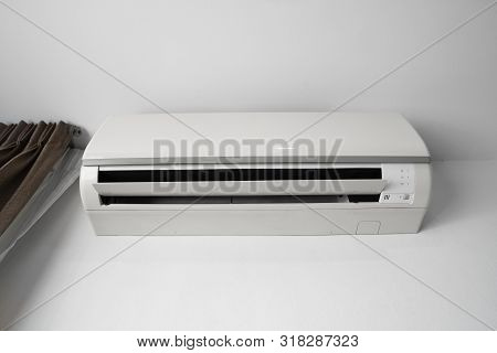 Air Conditioner Mounted On A White Wall In The Living Room Or Bedroom. Indooor Comfort Temperature. 