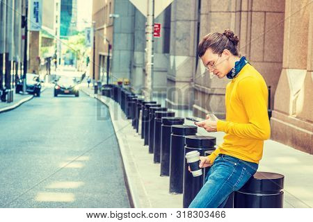 Working Break. Young Hispanic American With Hair Bun, Wearing Glasses, Yellow Long Sleeve T Shirt, B