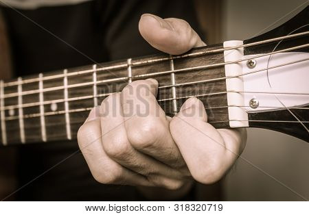 Guitar Player Hand Or Musician Hand In A Minor Chord On Acoustic Guitar String With Soft Natural Lig