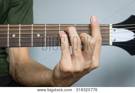 Guitar Player Hand Or Musician Hand In F Major Chord On Acoustic Guitar String With Soft Natural Lig