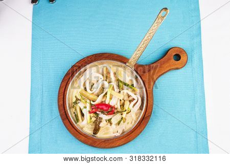 Mediterranean Noodle Soup With Colmar Rings, Onions, Cucumbers And Hot Peppers
