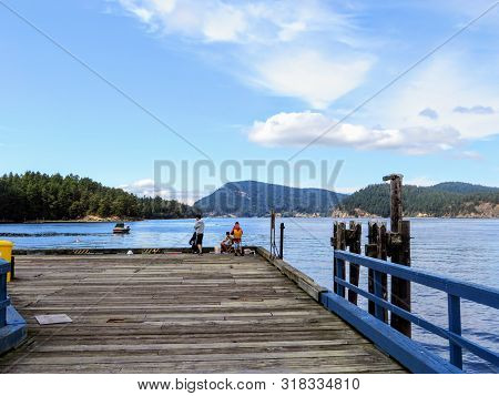 Mayne Island, British Columbia, Canada - July 9th, 2019: A Group Of Young Teenagers Fishing And Crab