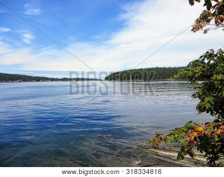 A Beautiful Fall View Of An Incredible Seascape With A Clear Calm Bay With Still Blue Waters And Aut