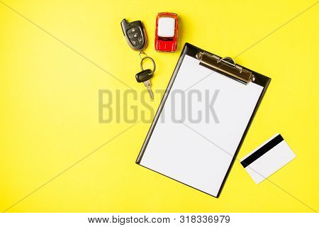 Paper Blank With Toy Red Car, Creadit Card And Keys On A Yellow Background. Technical Inspection Or 