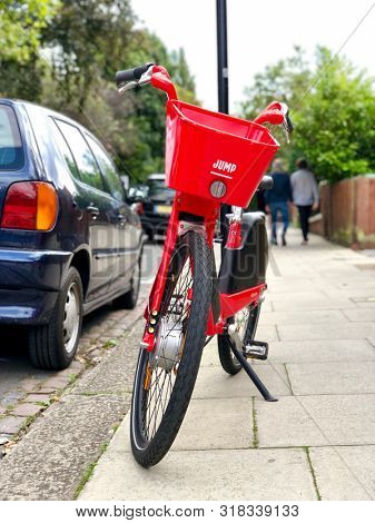 LONDON, UK - AUGUST 21, 2019: A Jump dockless electric bicycle parked on the pavement in a street in North London, UK.