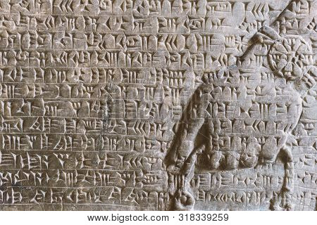 Ancient Assyrian Cuneiform Carved On Stone Wall