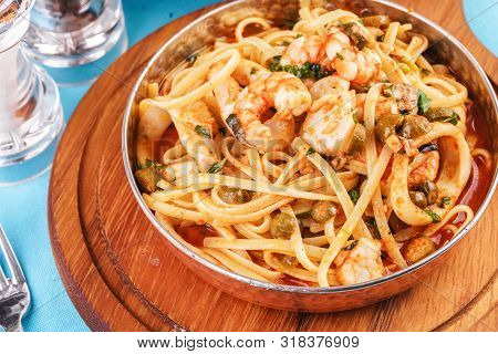 Mediterranean pasta with shrimps, onions, cucumbers and hot peppers