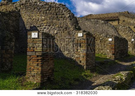 Pompeii, Italy Roman Architecture City Block Remains With Numbered Homes Entrances. Numbers In Doorw