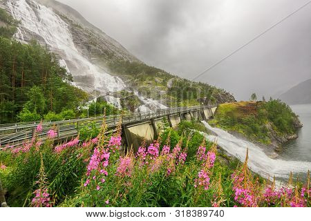 Waterfall Langfoss Located On The Lake Stordalsvatnet, Norway