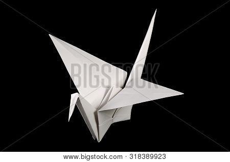 White Origami Crane, Tsuru, On Black Background. Japanese Art Of Paper Folding. Flat Square Sheet Of