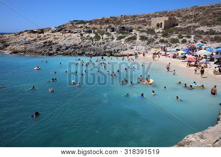 Qala, Malta - August 17, 2019: Many Unidentified People On The Beach Of Hondoq Bay. Island Of Gozo. 
