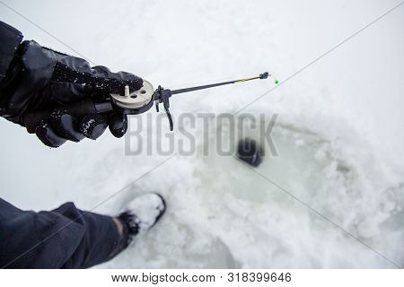 Close Up Of A Ricky Fisherman With A Fishing Rod. Ice And Fishing Rod For Winter Fishing. Winter Fis
