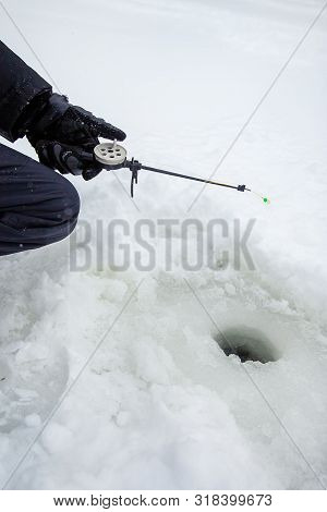 Close Up Of A Ricky Fisherman With A Fishing Rod. Ice And Fishing Rod For Winter Fishing. Winter Fis